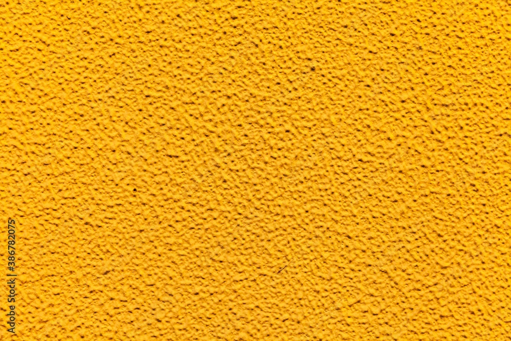 Rough patterned yellow cement wall texture and seamless background Rough patterned yellow cement wall texture and seamless background