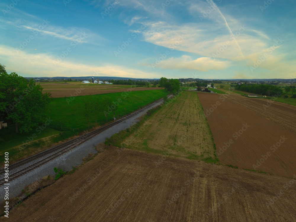 Aerial View of Pennsylvania Countryside with a Rail Road Track on a Sunny Day
