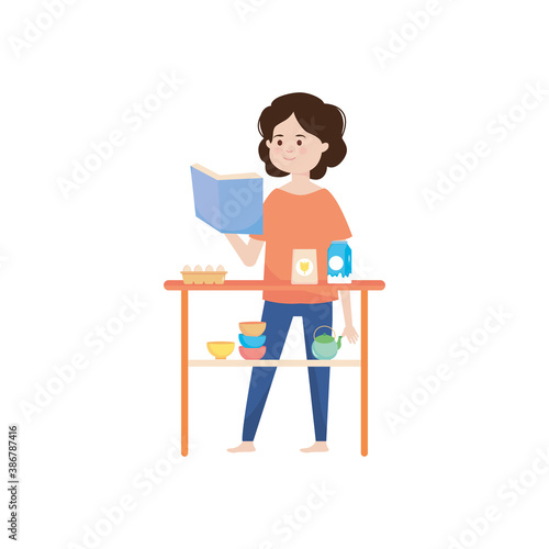 happy woman reading recipes book in the kitchen
