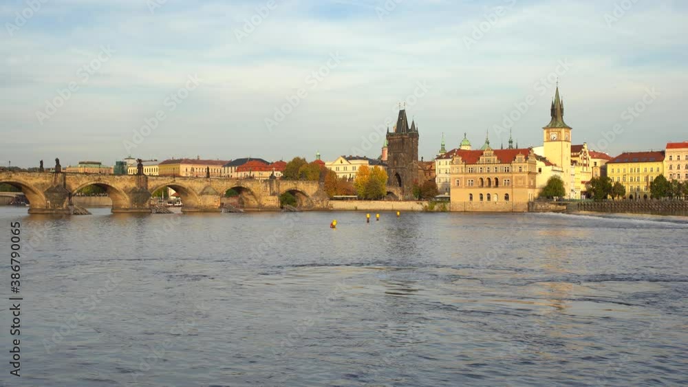 old stone Charles bridge from the 14th century on the surface of the Vltava river illuminated by the sun at sunset in the city center of Prague and clouds in the sky old stone Charles bridge from the 14th century on the surface of the Vltava river illuminated by the sun at sunset in the city center of Prague and clouds in the sky