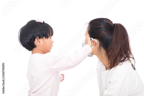 Daughter helps mother wear a mask