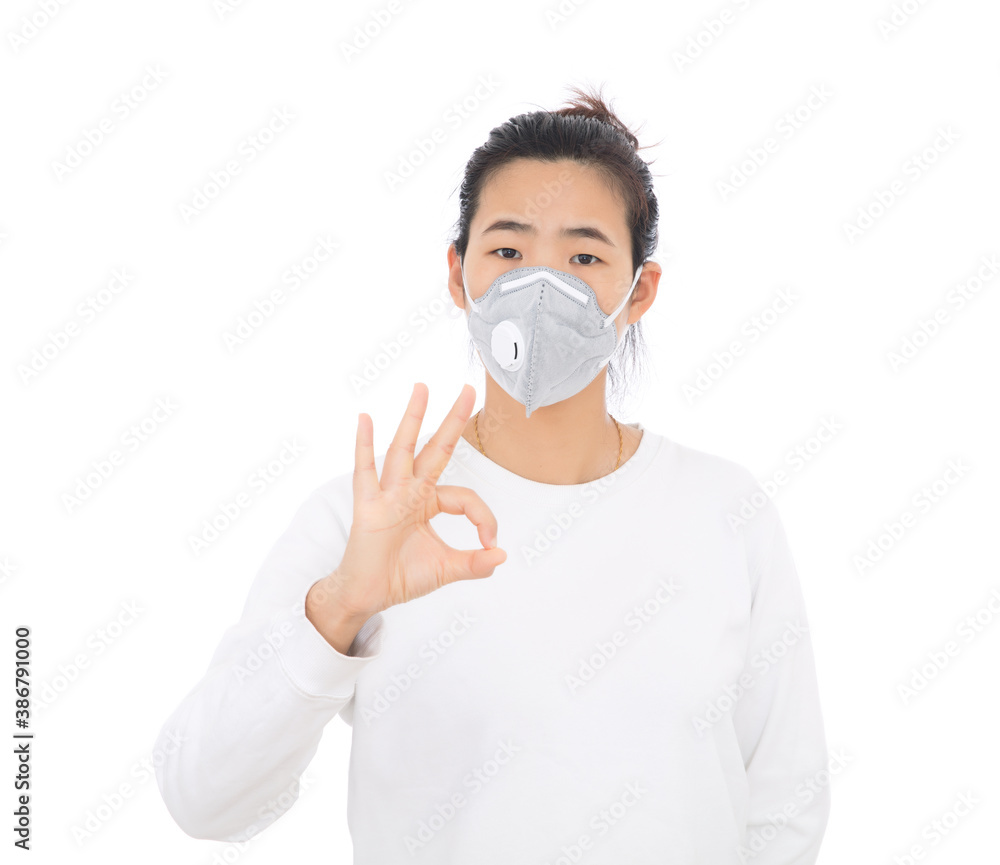 A lady wearing a mask makes an OK gesture A lady wearing a mask makes an OK gesture