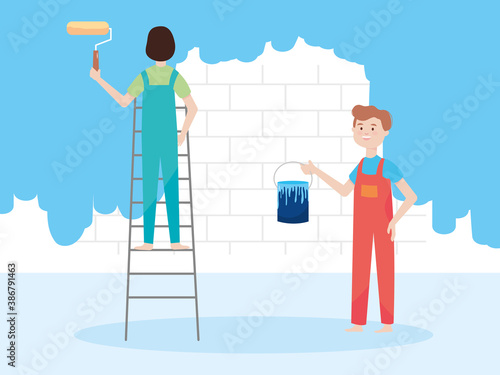 man on ladder with paint roller and another with bucket, wall remodeling