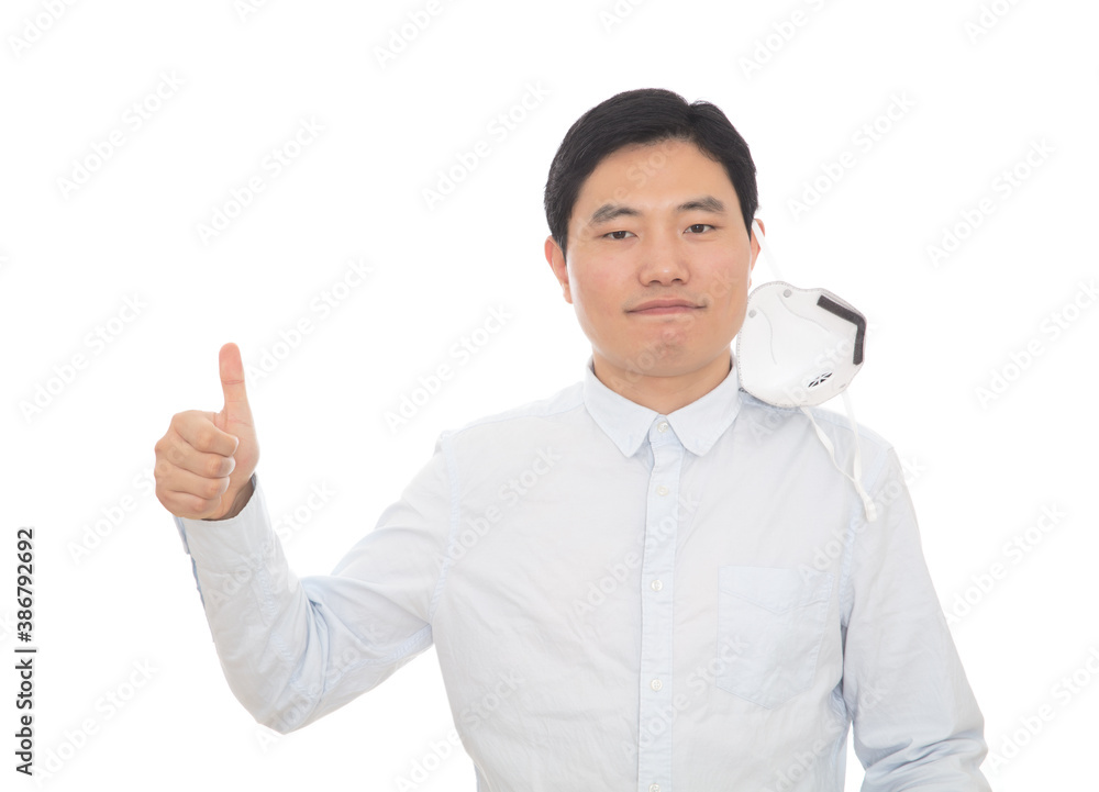 Man taking off his mask reaches for thumbs up Man taking off his mask reaches for thumbs up