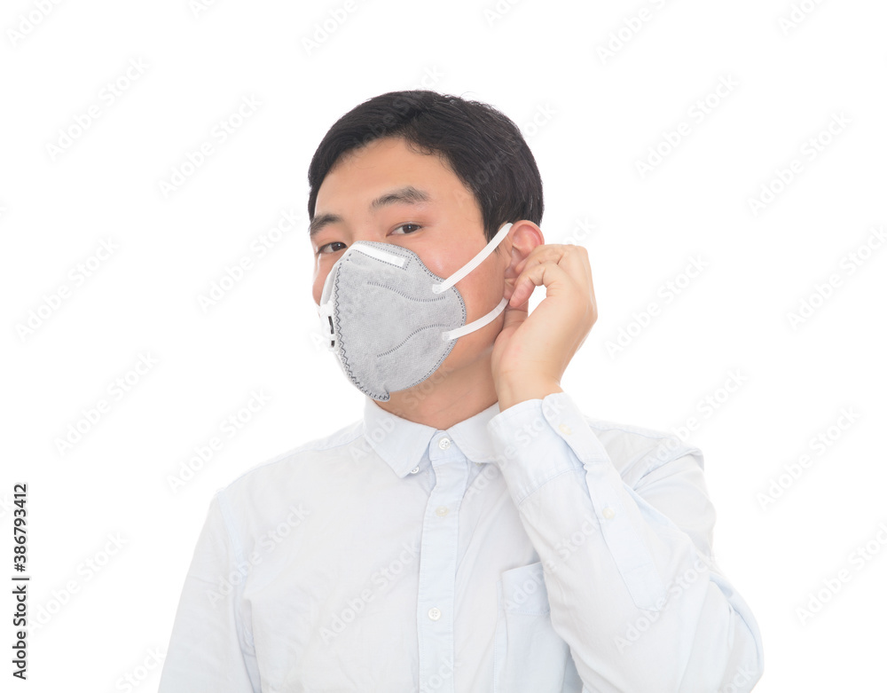 Young man preparing to take off his mask Young man preparing to take off his mask