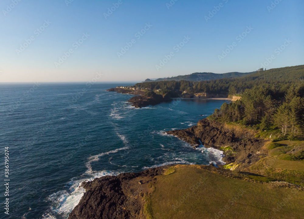 Aerial top view of green rocky cost with amazing blue ocean on sunny weather background. Wallpaper design. Fantastic landscape. Concept of beauty natural.