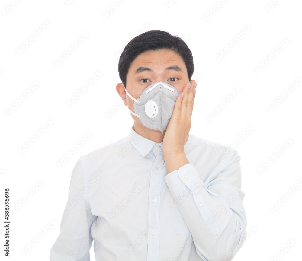 A man wearing a mask strokes his cheek with one hand A man wearing a mask strokes his cheek with one hand