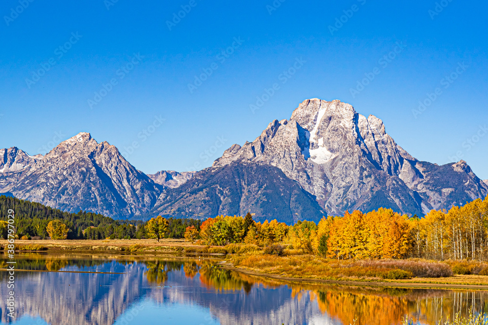 Autumn color in Grand Teton National Park reflected in the lake