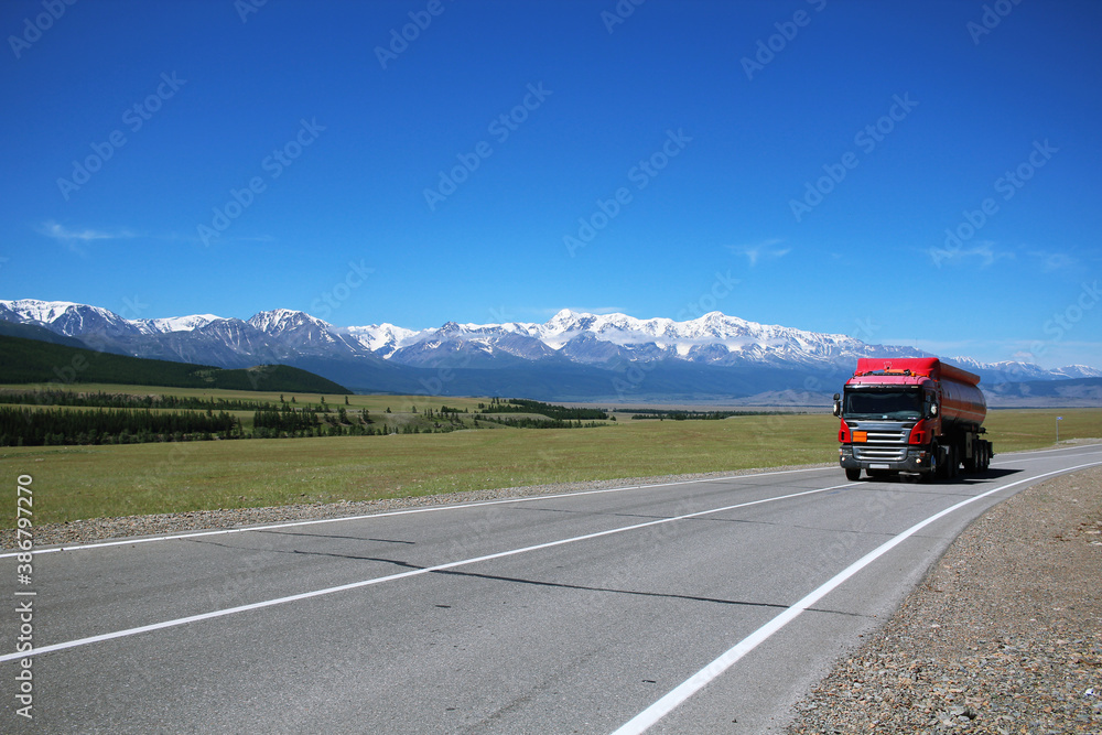 truck on the famous highway in Altai - Chuisky tract. The road, which is accompanied by the mountains. truck on the famous highway in Altai - Chuisky tract. The road, which is accompanied by the mountains.