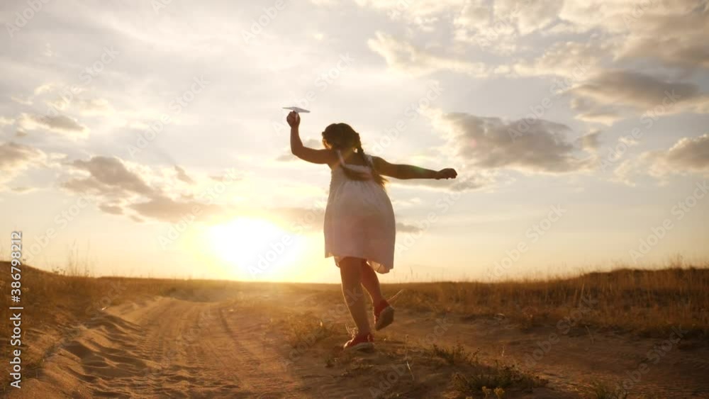 happy girl child run with an airplane. kid silhouette play plane. happy family dream freedom airplane concept. daughter kid run on wheat field at sunset holds in his fun hands dream toy aircraft happy girl child run with an airplane. kid silhouette play plane. happy family dream freedom airplane concept. daughter kid run on wheat field at sunset holds in his fun hands dream toy aircraft