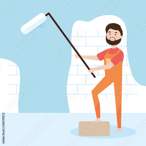 bearded repairman with paint roller blue wall remodeling
