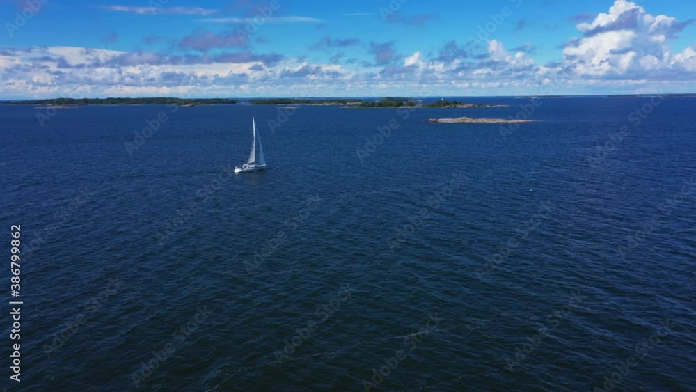 Drone shot towards a white sail boat, sailing on the high seas, on the Baltic ocean, bright, sunny, summer day, in Scandinavia - dolly, aerial view Drone shot towards a white sail boat, sailing on the high seas, on the Baltic ocean, bright, sunny, summer day, in Scandinavia - dolly, aerial view
