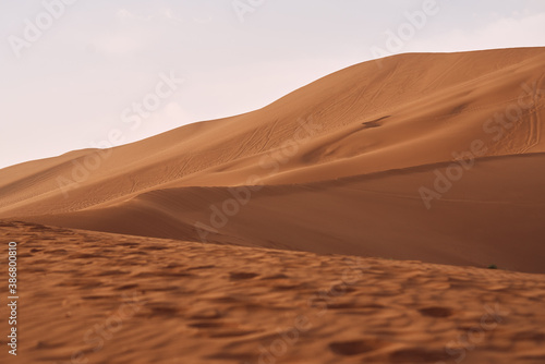 Sand dunes in the desert with orang color in Xinjian, China.