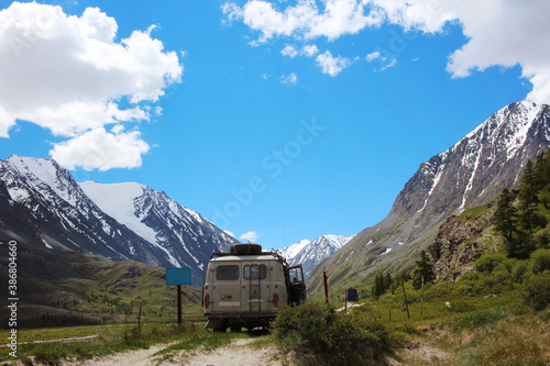 UAZ car enters the protected area surrounded by the Altai mountains