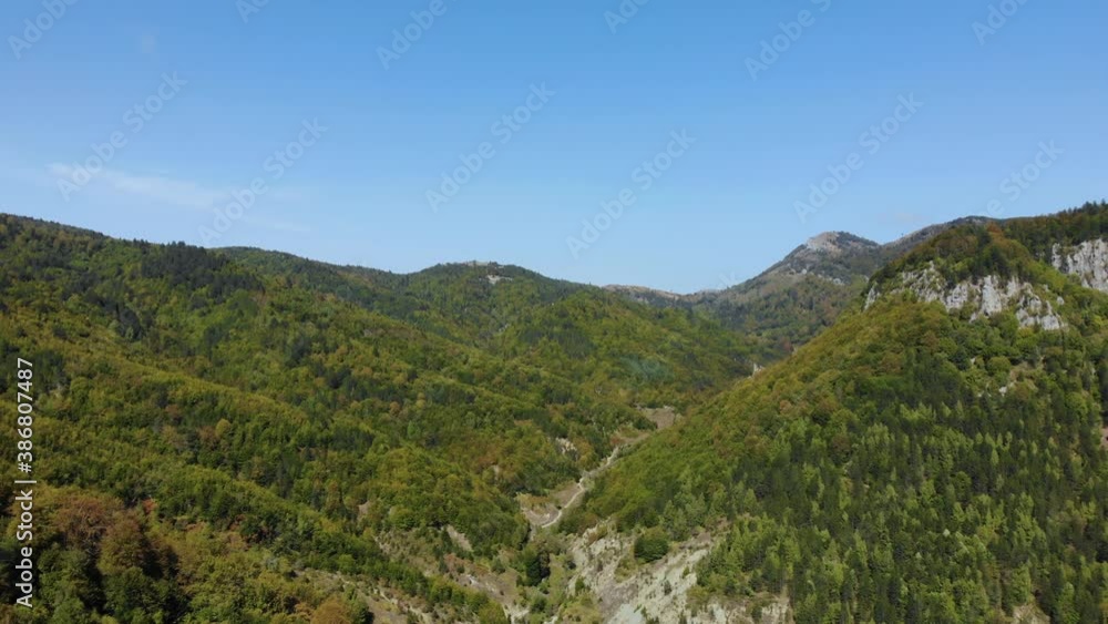 Paradise natural park valley across mountains covered in green and brown forest in Balkans Paradise natural park valley across mountains covered in green and brown forest in Balkans