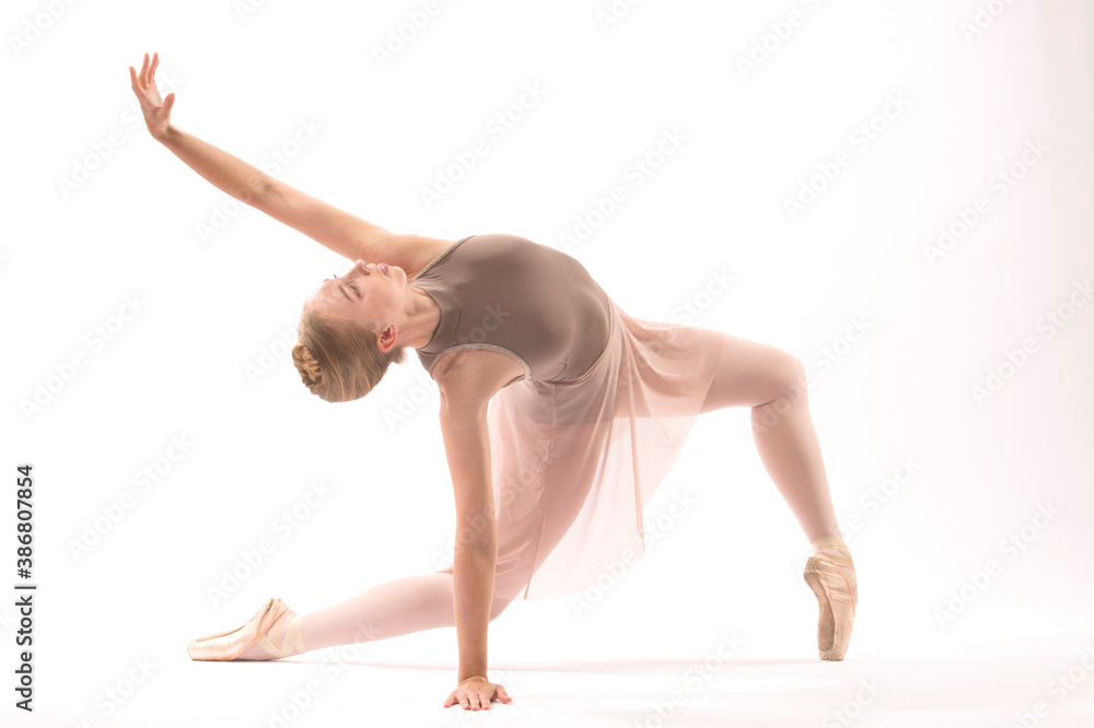 Young woman ballet dancer doing a lunge in the studio. Young woman ballet dancer doing a lunge in the studio.