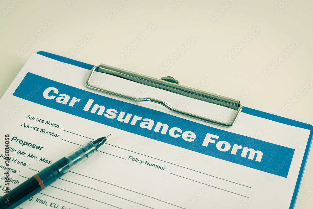 Car Insurance Claim Form or Auto Insurance Document and Pen at Left Frame and Clipboard on White Office Table in Vintage Tone Car Insurance Claim Form or Auto Insurance Document and Pen at Left Frame and Clipboard on White Office Table in Vintage Tone