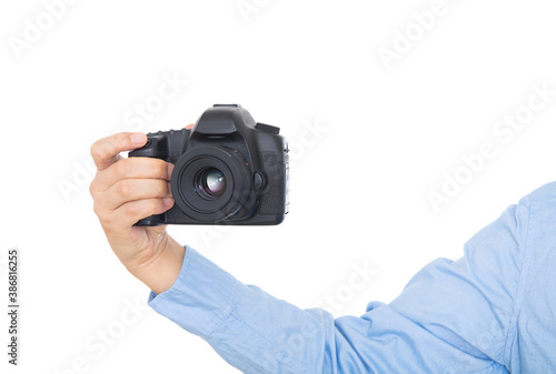 Hand holding black SLR camera close-up