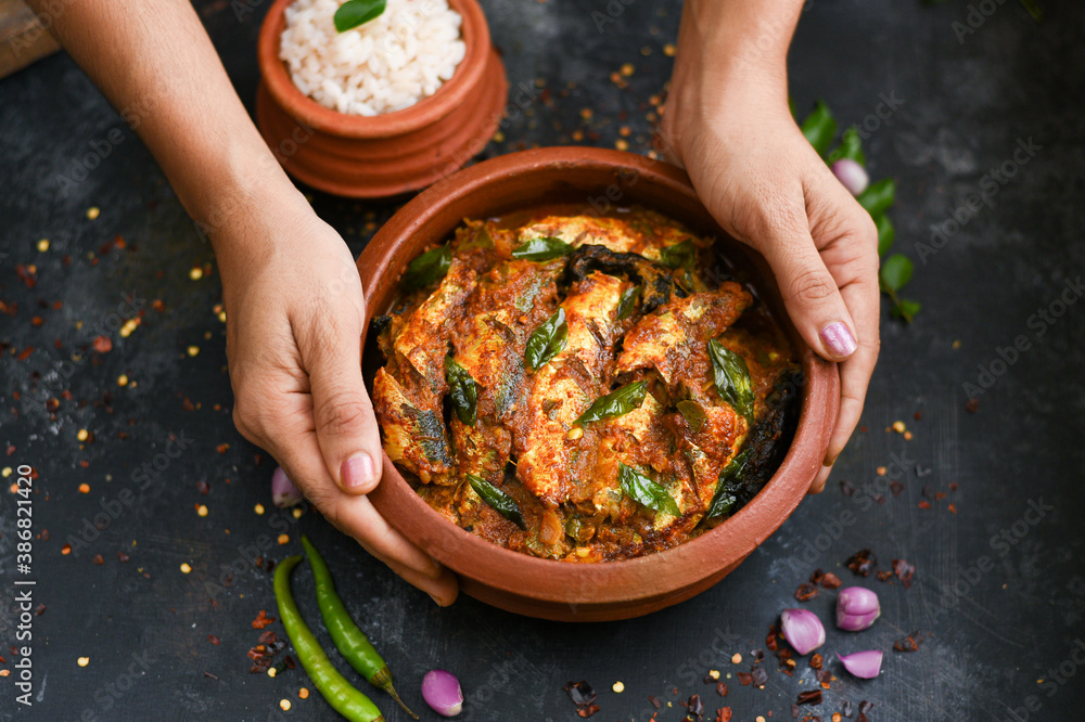 Top view Sardine fish curry spicy Woman hand take Kerala fish curry