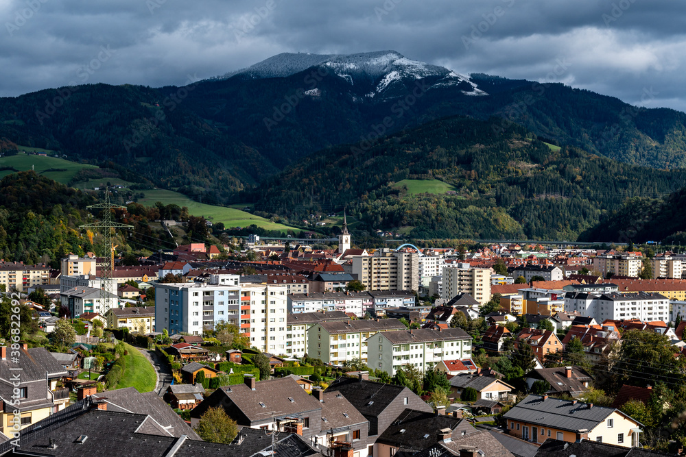 panoramic view of Bruck an der Mur city and the Rennfeld mountain in Styria, Austria on a sunny-cloudy autumn day