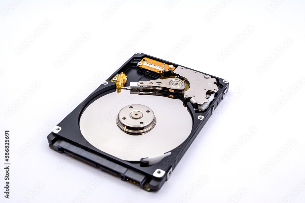 Internal parts of a hard disk isolated on a white background. Close up of Hard disk drive inside view. Internal parts of a hard disk isolated on a white background. Close up of Hard disk drive inside view.