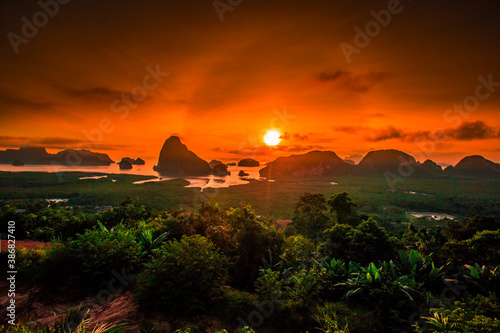 The natural background of the morning light rising in the middle of the sea and surrounded by mountains  cool breezes  the beauty of the ecology of the tourist attractions.