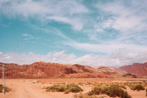 Rock mountains in dessert with blue sky and cloud in Xinjian, China.