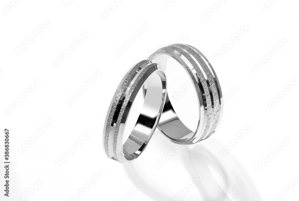 Golden wedding ring on a white background.