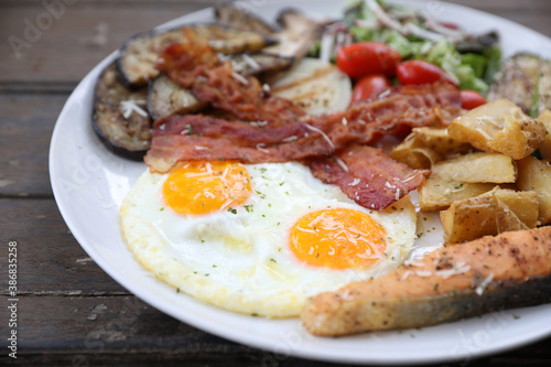 American breakfast with egg bacon sausage and salad