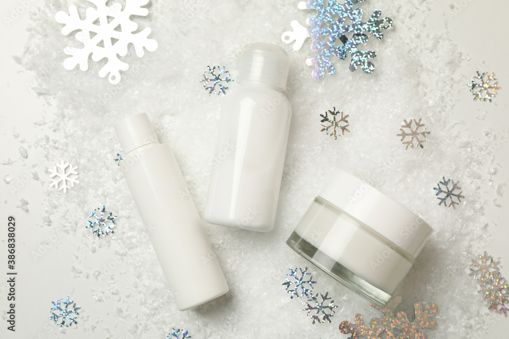 Cosmetics on white background with decorative snow Cosmetics on white background with decorative snow