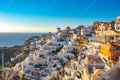 SANTORINI, GREECE - AUG 9, 2020: Santorini White houses of island with colorful volcanic cliffs and deep blue sea.