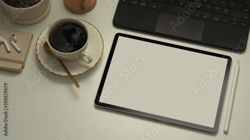 Workspace with tablet, keyboard, coffee cup and supplies, include clipping path