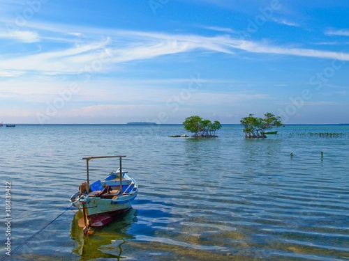 traditional boats parked on crystal clear beaches