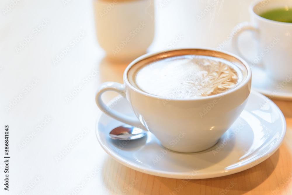hot coffee on table / hot cappuccino with nice pattern milk foam hot coffee on table / hot cappuccino with nice pattern milk foam