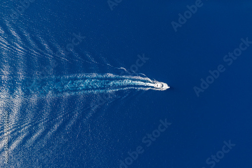 Motorboat and white wake on rippled sea background