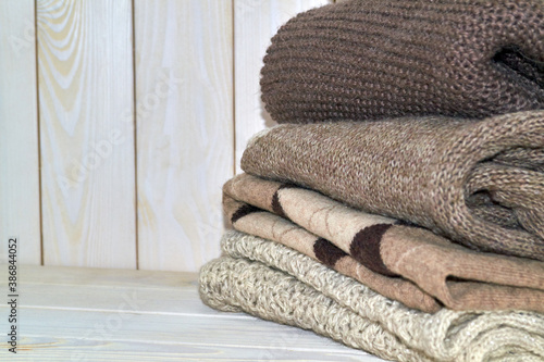 A stack of knitted sweaters, comfort and coziness in the cold season