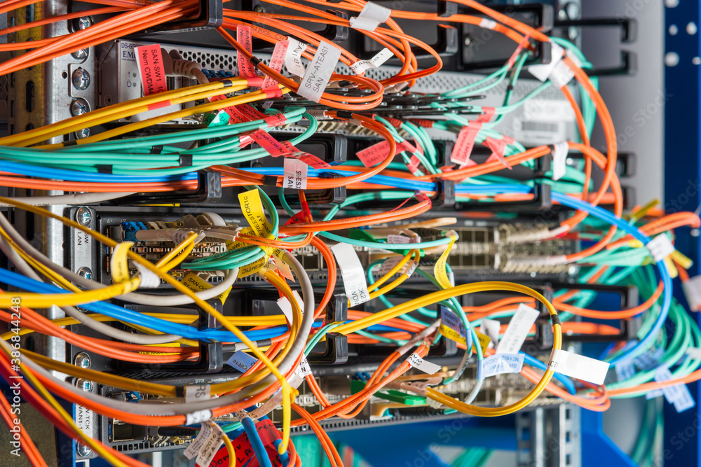 detail of server rack with fiber optic cables attached to front detail of server rack with fiber optic cables attached to front