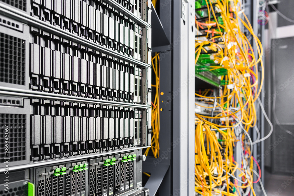 Server rack with fiber optic cables attached to switch