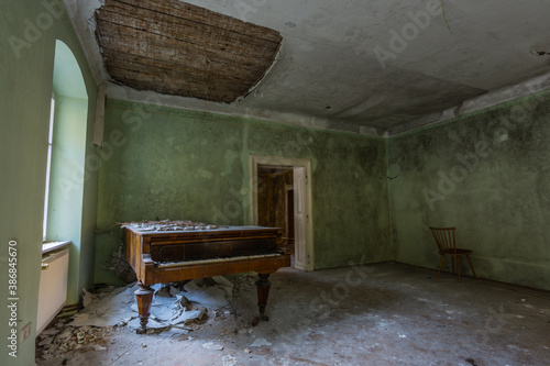 old piano with collapsed ceiling from a green room