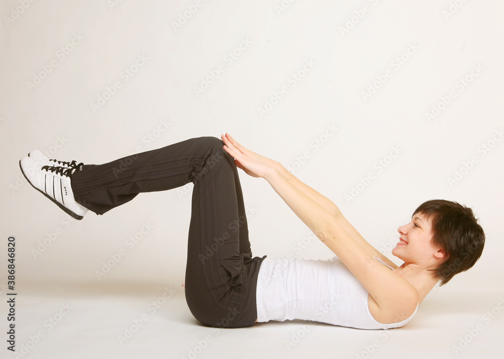 Fototapeta premium woman doing stretching exercise at the gym