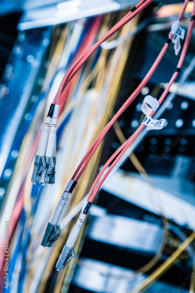 Detail of server room with bunch of fiber optic cables at the ba Detail of server room with bunch of fiber optic cables at the ba