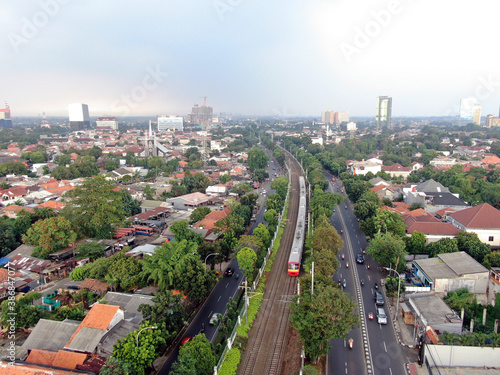 Aerial drone view of KRL commuter line Jabodetabek JR205 electric train near Pasar Minggu, Jakarta, Indonesia photo