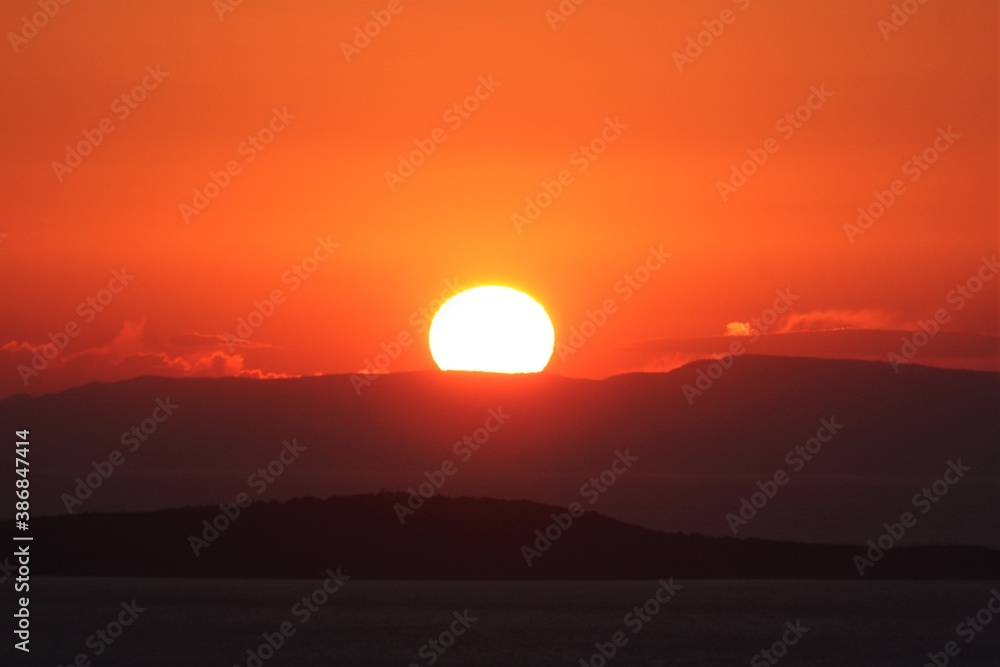 Fototapeta premium Panoramic view of Aegean sea during sunset. Sunset view during bright weather from Devil's Dinner Table in Ayvalk, Balikesir, Turkey.