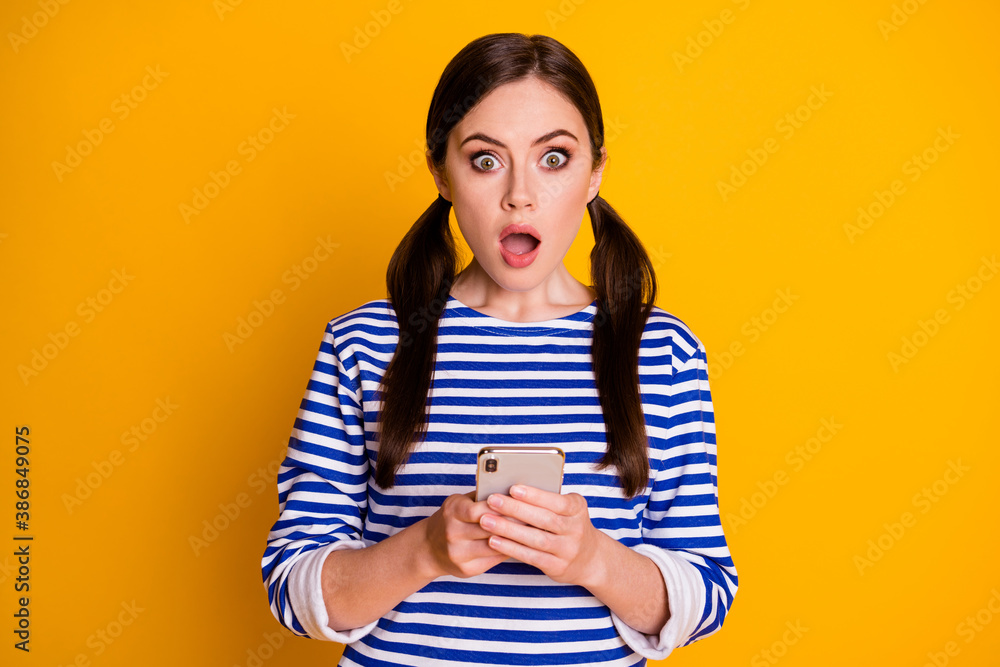 Portrait of astonished girl use cellphone impressed social network coronavirus information stare stupor wear good look outfit isolated over bright color background Portrait of astonished girl use cellphone impressed social network coronavirus information stare stupor wear good look outfit isolated over bright color background