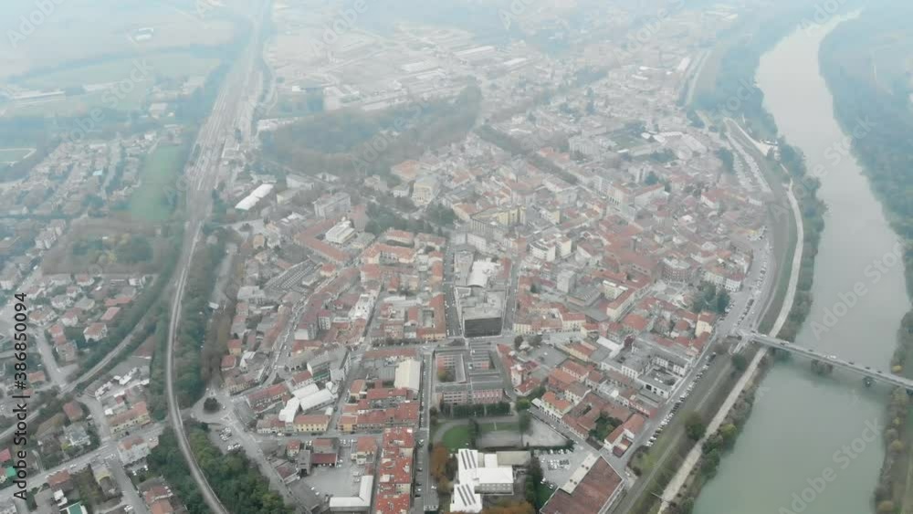 Aerial image of an Italian city crowded with fog in the evening. Aerial image of an Italian city crowded with fog in the evening.