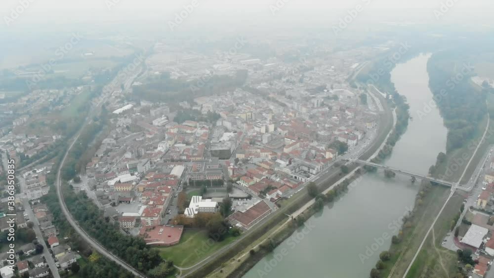 Aerial image of an Italian city crowded with fog in the evening. Aerial image of an Italian city crowded with fog in the evening.