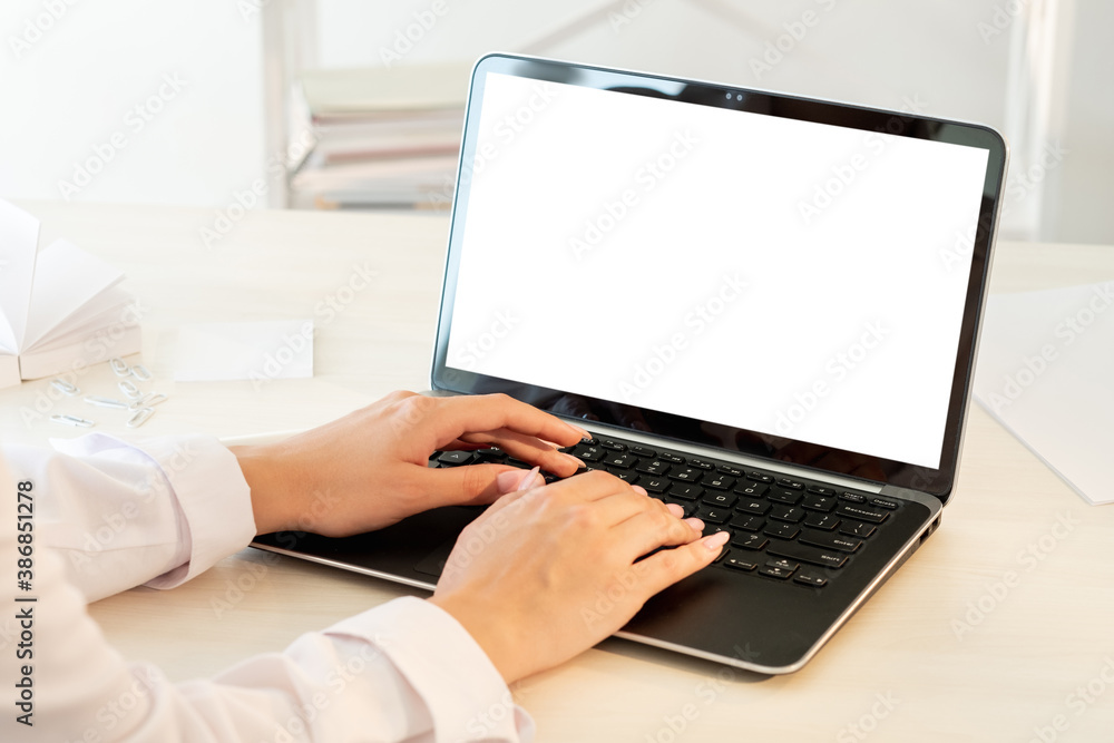 Working laptop. Copywriting job. Digital technology. Unrecognizable female hands typing on portable computer blank screen light workplace interior copy space. Working laptop. Copywriting job. Digital technology. Unrecognizable female hands typing on portable computer blank screen light workplace interior copy space.
