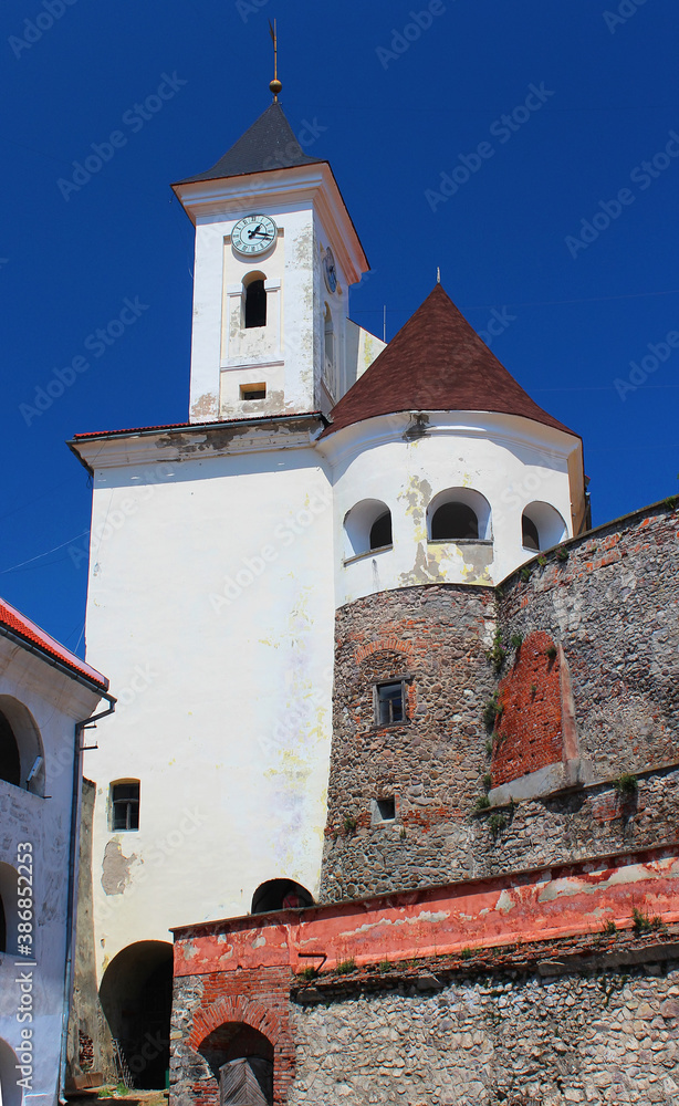 Clock Tower of ancient castle Palanok (also known as Munkacs Castle) in Mukachevo, in Transcarpathia, Western Ukraine. Ukrainian landmark.