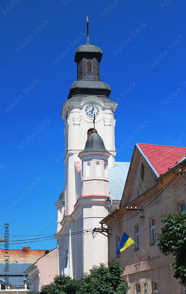 St. George Church in Uzhhorod city. It is a Roman Catholic church built in 1762-1766 in a late Baroque style. City clock placed on the tower. Transcarpathia, Western Ukraine.