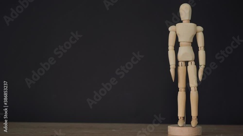 wooden statue on a black background. photo